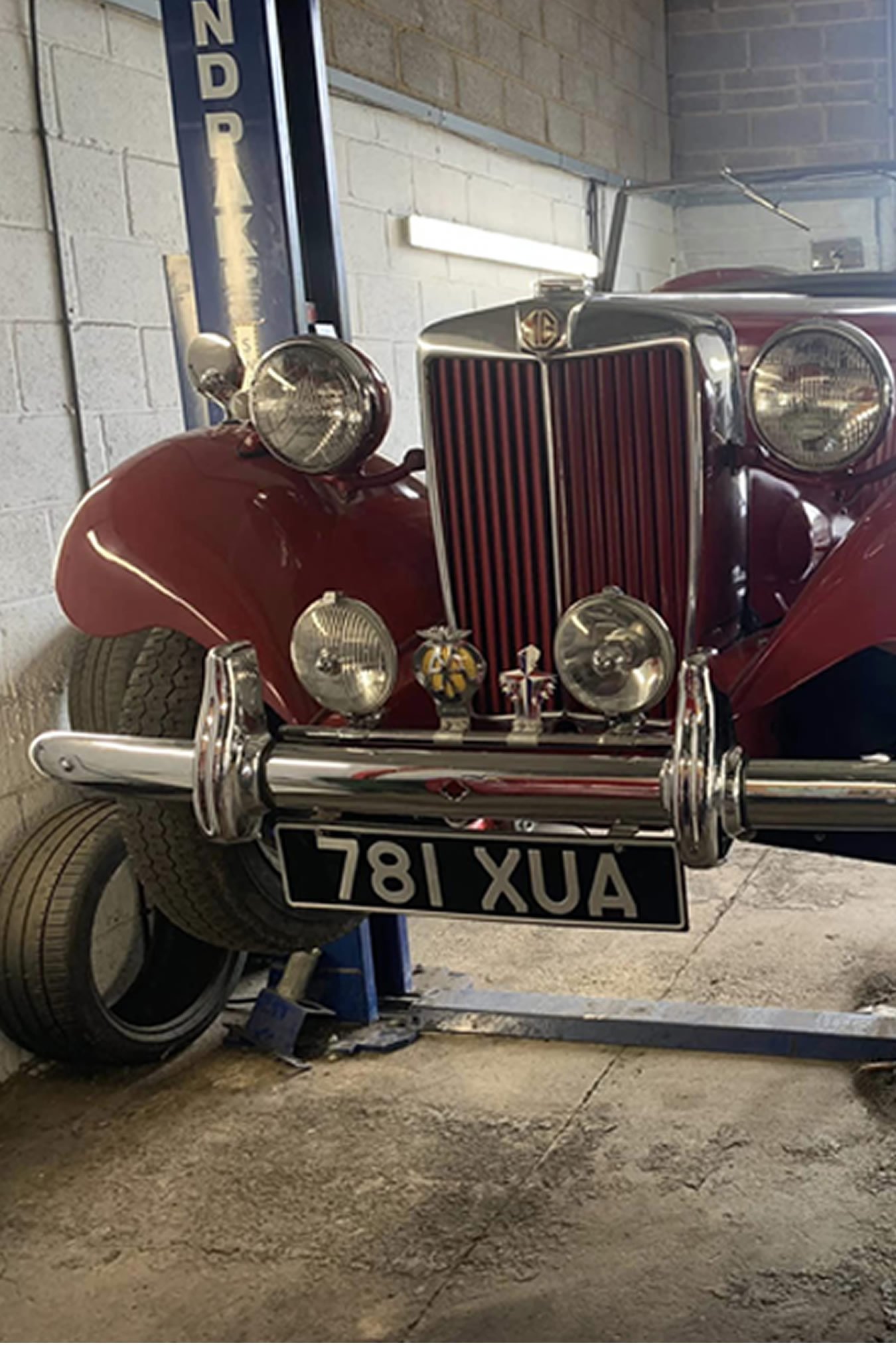 Picture - Classic car on two post lift in GB Transport Services