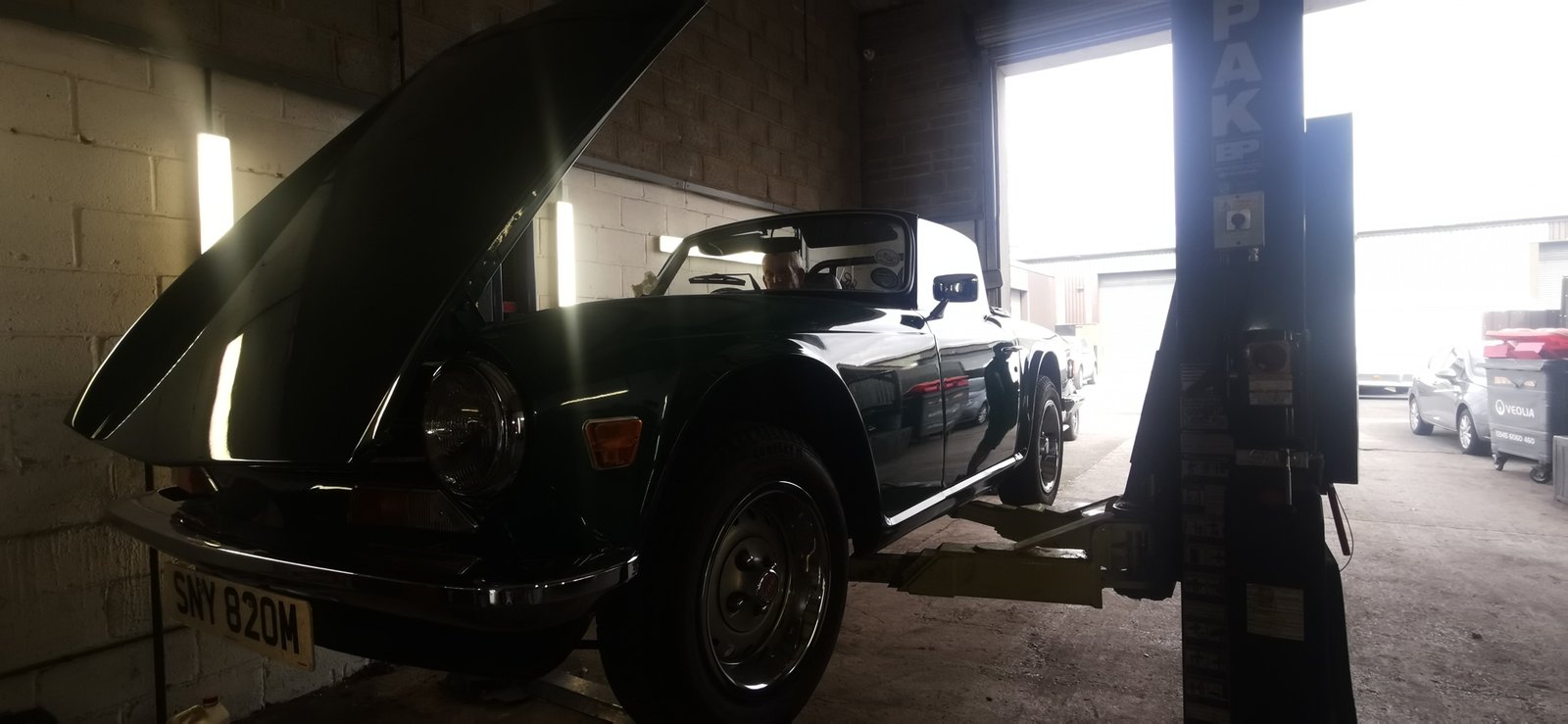 picture - classic TR6 on the 2 post lift at GB Transport Services